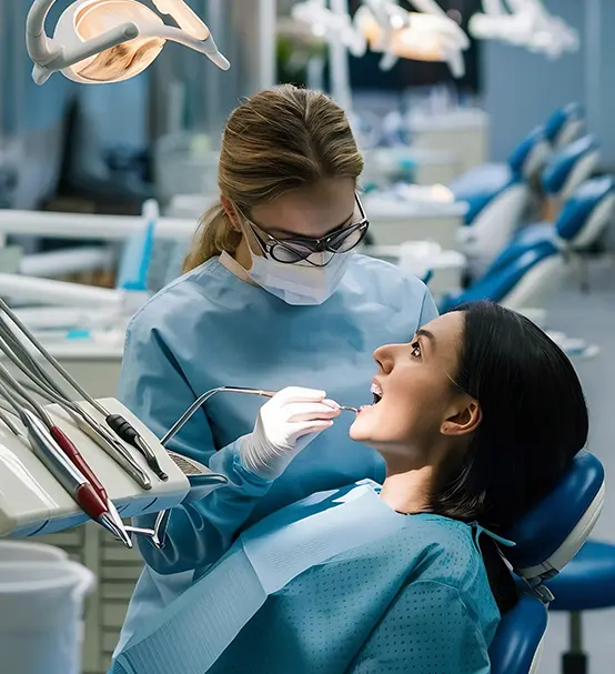Dentist explaining Medicare and Medicaid dental coverage options to a patient at First Care Dental clinic.
